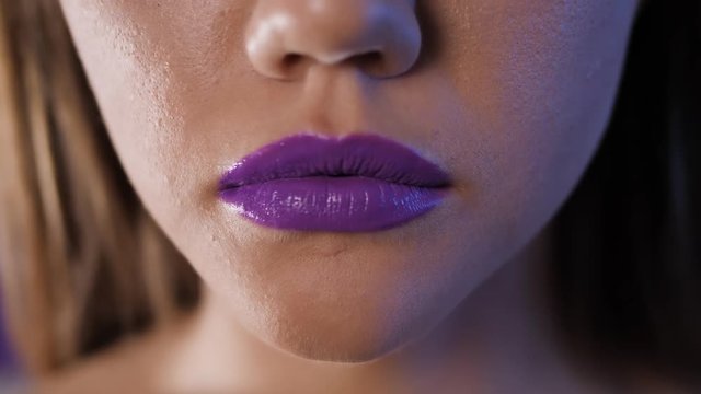 Beautiful make up of glamour purple lips, lipstick on the face of an attractive beautiful woman as a beauty and health concept girl model fashion