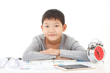 Little asian boy Lay on study desk with smiling face on white background. Planing Education Concept.