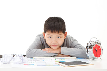 Little asian boy Lay on study desk with smiling face on white background. Planing Education Concept.