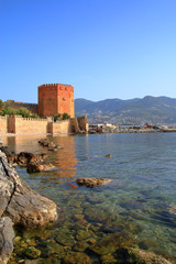 Alanya city bay landscape with visible ancient red tower.