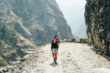 Hiking in Himalaya. Woman Traveler in the Mountains