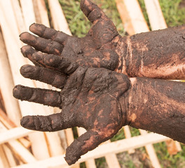 children's hands in the mud