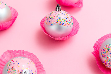 Christmas decorations pink color on pink background. Christmas time