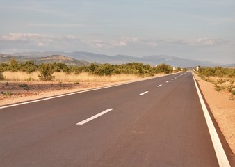 Long straight road with mountainous view in Croatia