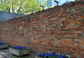 Remaining fragment of the Jewish ghetto wall in Warsaw, Poland - obrazy, fototapety, plakaty