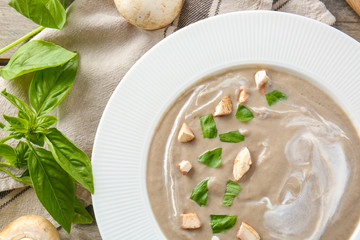 Plate of tasty mushroom cream soup on table