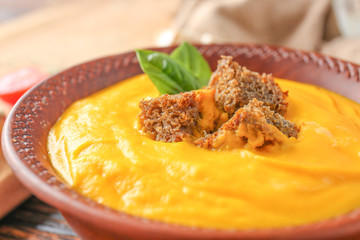 Tasty pumpkin cream soup in bowl, closeup