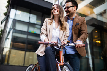 Office woman with business man couple enjoying break while talking flirting outdoor