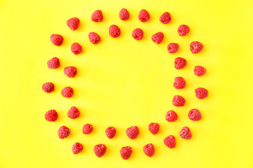 Frame made of sweet ripe raspberry on color background