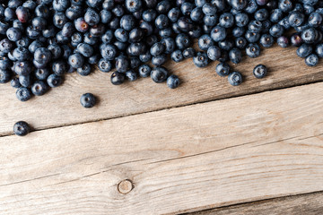 Delicious blueberries on wooden background with copyspace. Top view