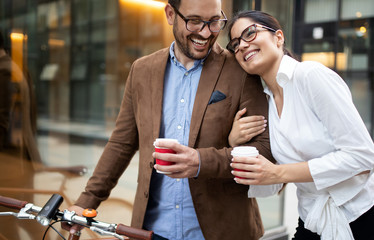 Attractive young business couple embracing at street