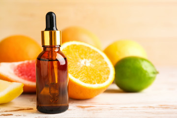 Bottle of citrus essential oil on table