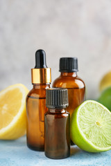 Bottles of citrus essential oil on table