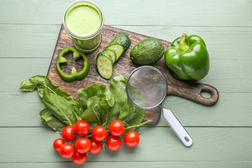 Glass of fresh healthy smoothie and ingredients on wooden background