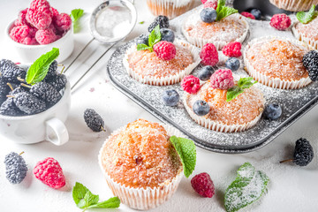 Muffins or cupcakes with berries