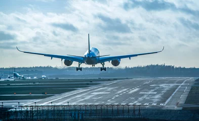 Fotobehang Airplane landing to airport runway © citikka