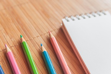 Notepad with pencil on wood board background.using wallpaper for education, business photo.Take note of the product for book with paper and concept, object or copy space.