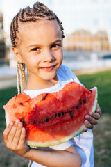Little girl eating watermelon