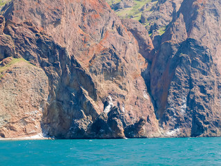 Textured rocks of volcanic origin on the sea coast