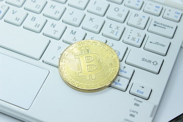 Physical gold bitcoin on the keyboard