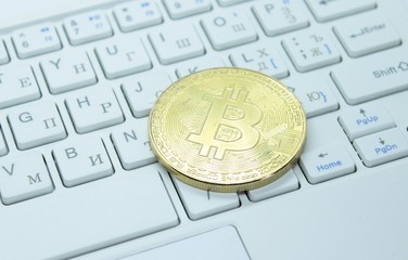 Physical gold bitcoin on the keyboard