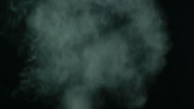 Smoke plumes on black background. Blend in screen mode overlays to add smoke effect to footage.
Steamy smoke from the bottom of the frame