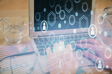 Social network theme hologram with businessman working on computer on background. Concept of world...