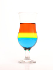 Glass and colored liquids on white background