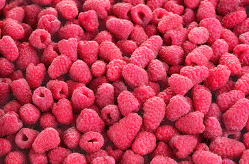 heap of fresh raspberries on as textured background