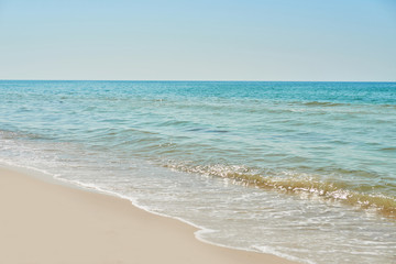 Fototapeta premium View of beach and sea, blue water. Tourism and vacation on ocean. Family vacation in summer. Vacation at sea . Summer travel.