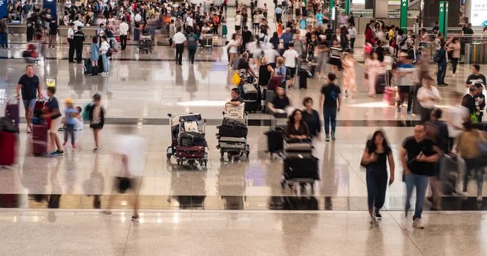 Time lapse of crowd people walking with luggage in the airport. Hong Kong International Airport.