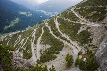 U-shape curved road towards Towers of Fraele, a touristic attraction in North Valtellina, Italy.