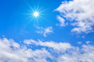 Naklejka na ściany i meble blue sky with hugh white clouds and sun background