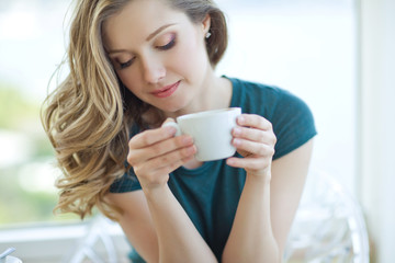 Woman drinking coffee. 