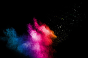 Abstract colorful powder explosion on black background.Freeze motion of dust splash.Painted Holi.