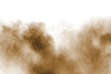 Freeze motion of brown dust explosion. Stopping the movement of brown powder. Explosive brown powder on white background. - obrazy, fototapety, plakaty