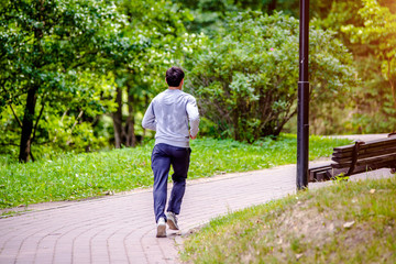 A man Jogging in a summer Park 
