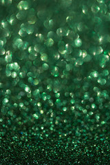 green Lights Festive background with texture. Abstract Christmas twinkled bright bokeh defocused and Falling stars.
