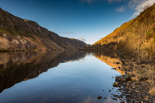 Early morning sunlight hits the waters of Loch Awe, Highlands, Scotland