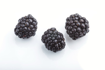 Three ripe dewberry isolated on white background. side view.