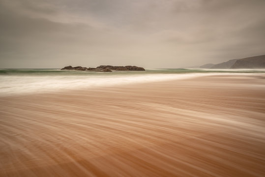 Sandwood Bay in early morning with Cape Wrath in far distance, Sutherland, Scotland