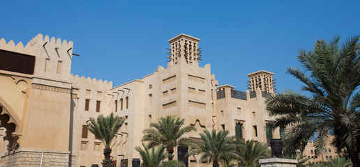 traditional Arab wind tower for air conditioning and cooling on top of building in Dubai, United Arab Emirates