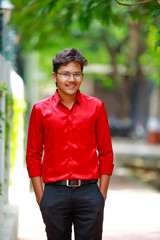 Indian / Asian Collage boy in red shirt and wearing spectacles