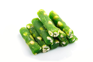 green traditional turkish delight (rahat lokum) with peanuts isolated on white background. side...