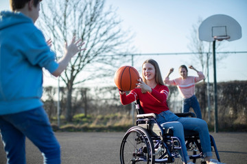 Teenage Girl In Wheelchair Playing Basketball With Friends © Daisy Daisy