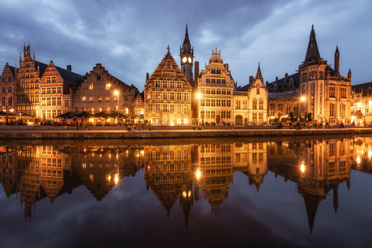 Graslei in the historic city of Ghent reflected in Leie river during blue hour, Ghent, East Flanders, Belgium
