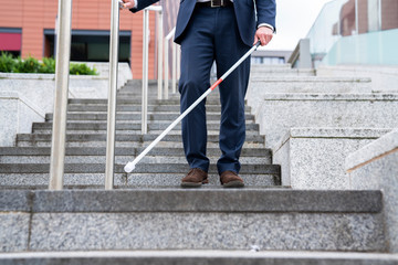 Close Up Of Blind Person Negotiating Steps Outdoors Using Cane