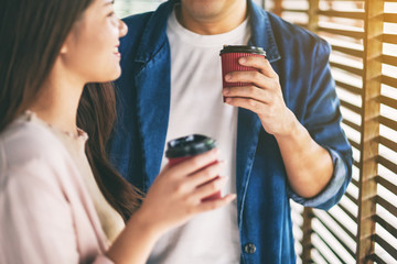 A man and a woman drinking coffee together