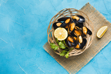 Flat-lay cooked mussels basket with copyspace