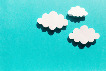 blue background with white clouds and shadows